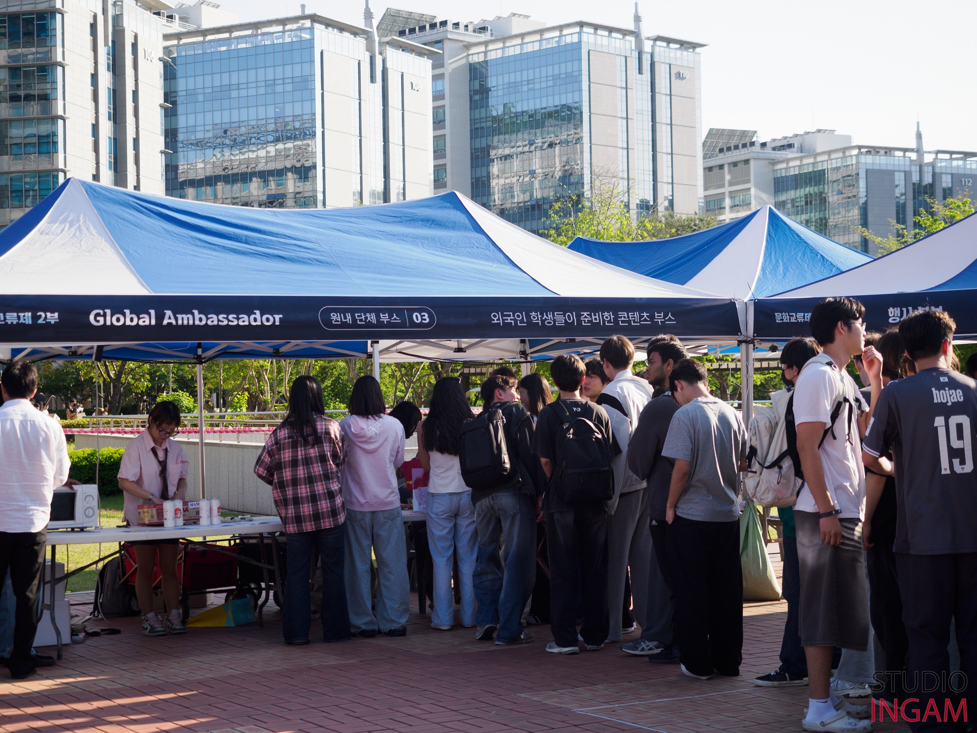 Visitors gather at the Global Ambassador booth during the 2026 UNIST Cultural Festival. | Image Credit: STUDIO INGAM